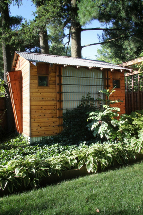 Maison de jardin dans l'arrière-cour panneaux de bois façade arbuste de toit