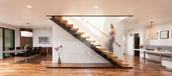 Modern wooden staircase glass railing hovering in the living room