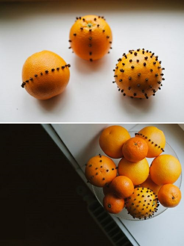 Коледните украшения правят портокали с пъпчици в купа
