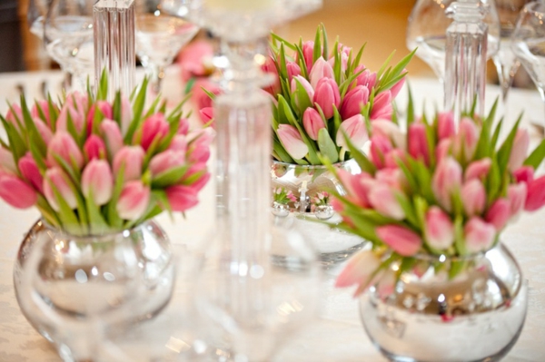 Flower arrangements make festive table decoration with tulips