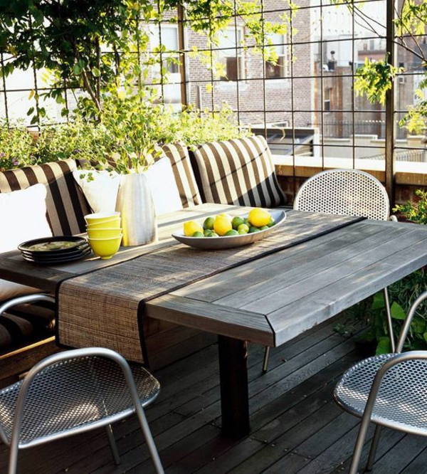 Roof terrace design ideas wooden table bench chairs climbing plants balcony