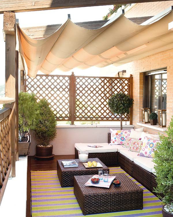 balcony set up sunscreen wicker furniture cushions wooden deck