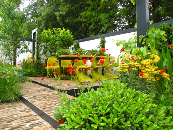 κήπος ιδέες κήπο πέτρινα πλακάκια σκάλες πράσινα φυτά τραπεζαρία τραπέζι πλαστικές καρέκλες
