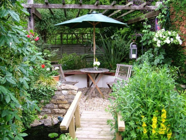 idées de jardin pergola ronde table pliante chaises parasol pierres gravier été jardin forme