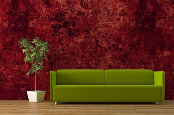 green couch and red wallpaper
