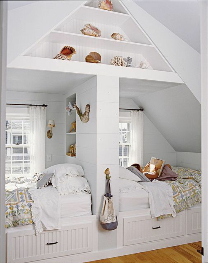 children's room with sloping two beds drawers built wall shelves findings