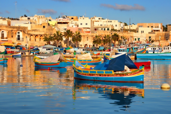 malta holiday Marsaxlokk fishing village history sea boats old building palms