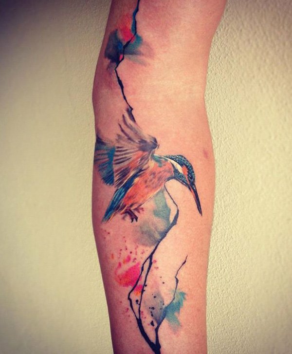 upper arm tattoo tribal flowers colorful bird