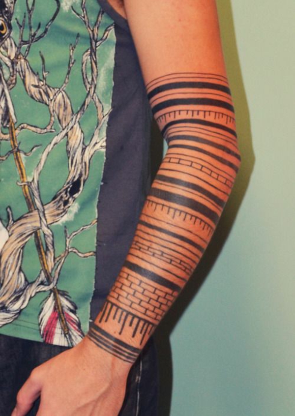 upper arm tattoo tribal flowers stripes