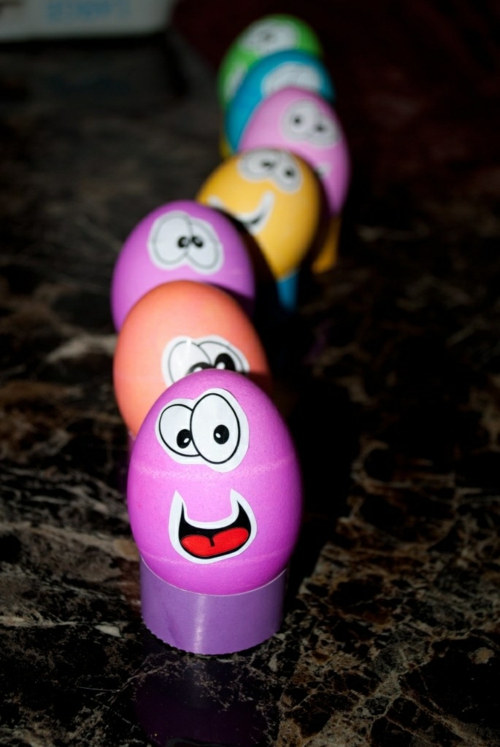 Easter eggs with face. Colorful caterpillar