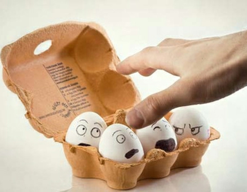 Easter eggs with face in carton
