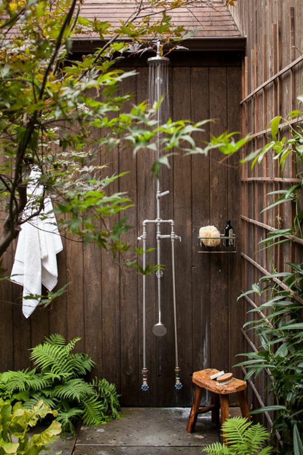 outdoor shower summer bathroom wood walls garden plants rustic