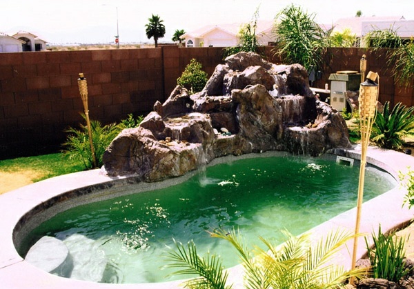 басейн в градината облицована с бъбреци градина визуална защита ограда камъни тухла