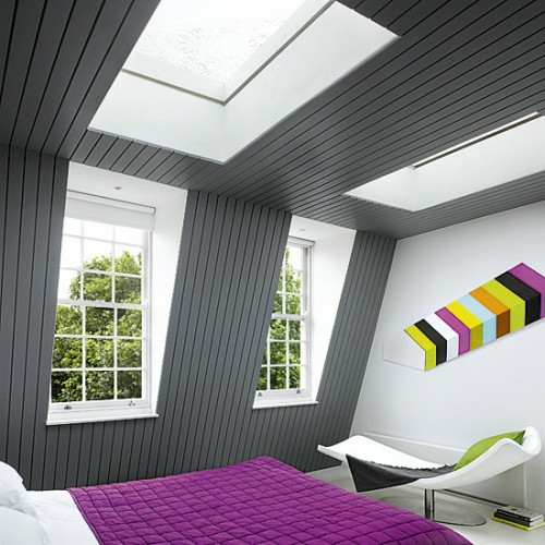 slaapkamer op de zoldergrijze muur die roze beddenspreider dakvenster behandelt