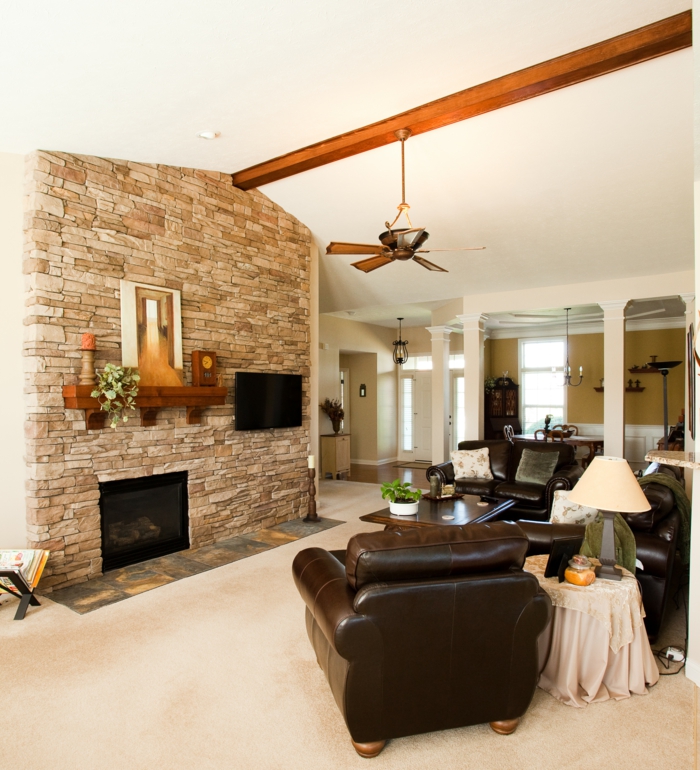 stone wall bedroom accent wall fireplace leather chair