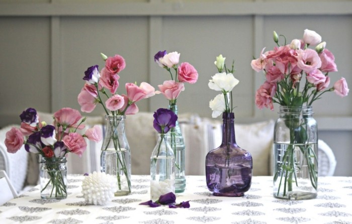 Les fleurs de décoration de table dans des vases en verre créent un look festif et sans couture