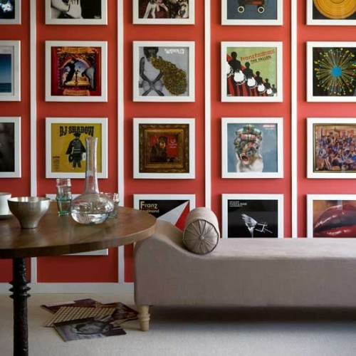 стена декорация с картини диван екстравагантен оранжев цвят дървена маса