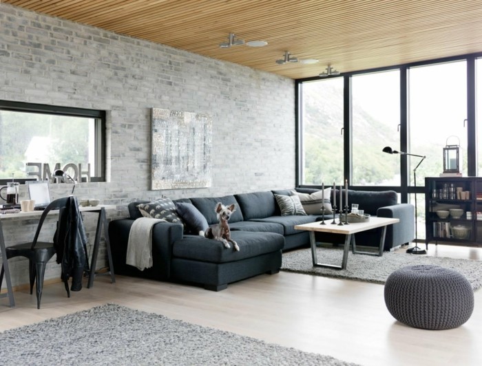 living ideas sala de estar plan abierto sofá oscuro piedra pared gris claro alfombras