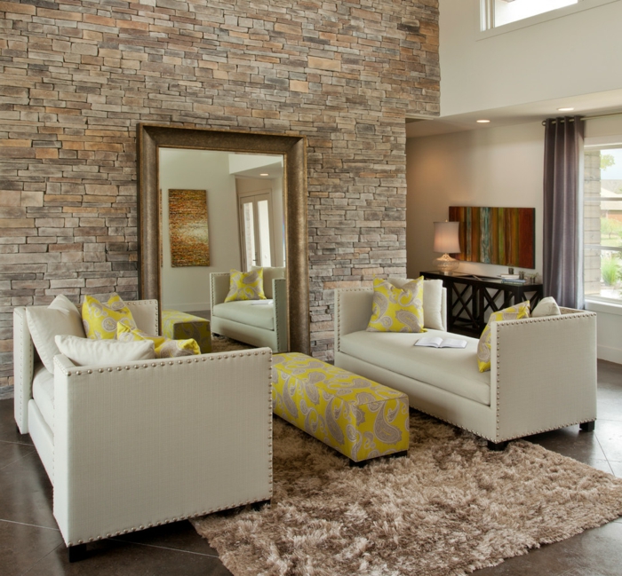 living stone wall yellow accents stylish sofas