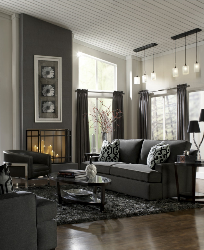 room facility-living room-gray-furniture-carpet-fireplace-light fixtures